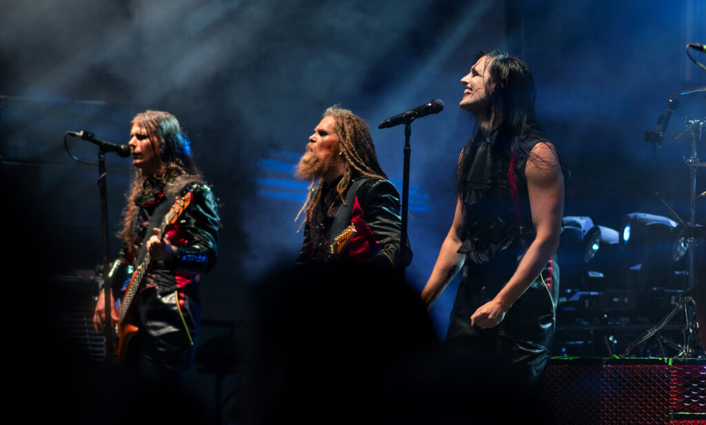 Three members of Avatar on stage